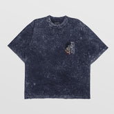 A Jujutsu Kaisen Toji Fushiguro Vintage Oversized T-Shirt in distressed black denim features short sleeves and a left chest graphic design in red, gray, and white with text and an abstract pattern.