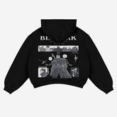 The back of the Official Berserk Manga Panel Hoodie, crafted from premium 360 GSM cotton, features a black collage design with monochromatic illustrations and text. "BERSERK" appears in bold white letters at the top alongside the iconic Brand of Sacrifice.