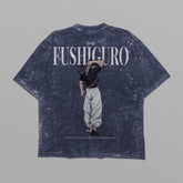 The distressed black Jujutsu Kaisen Toji Fushiguro vintage oversized T-shirt, from the Jujutsu Kaisen brand, features a graphic of a person in white pants and dark top lifting another on their shoulders, with "FUSHIGURO" printed boldly above the scene.