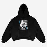 The Attack on Titan Levi Hoodie is an oversized black streetwear piece featuring manga-style face illustrations in black and white panels, blue and white Japanese text, and the iconic Scouting Legion emblem on the sleeve. It includes a large front pocket and a hood.
