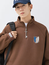 Wearing a Limited Edition Attack on Titan Half-Zip Sweatshirt with Eren’s key zipper and the Scout Regiment logo, they sport a dark blue cap and backpack, channeling the adventurous spirit of "Attack on Titan.