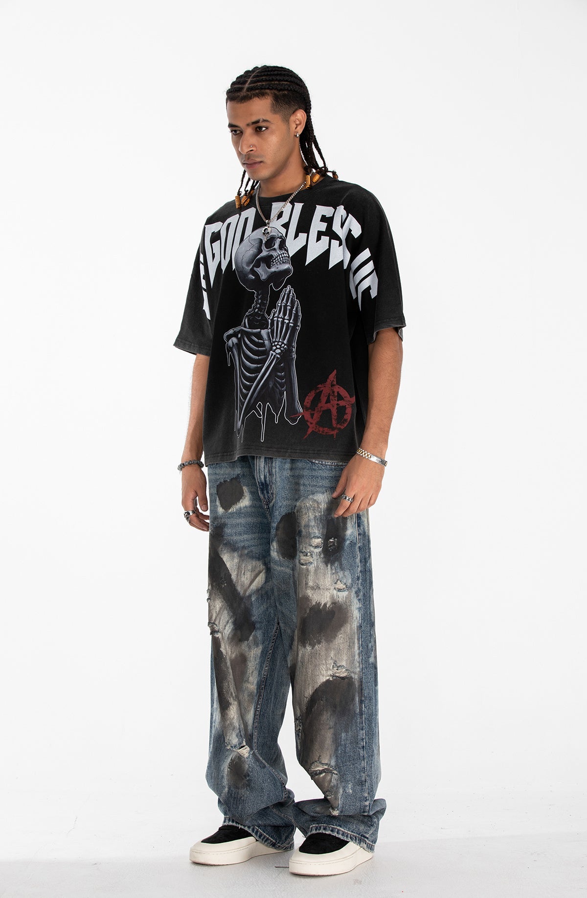 Oversized black gothic graphic tee with skeleton print and bold white lettering on a male model