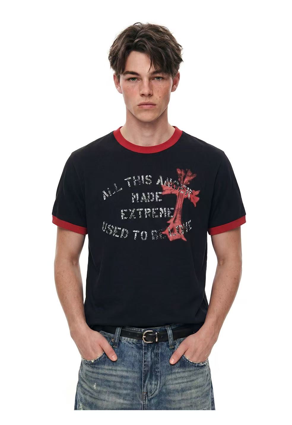 Black ringer T-shirt with red trim and distressed cross graphic, worn with faded blue jeans on a male model