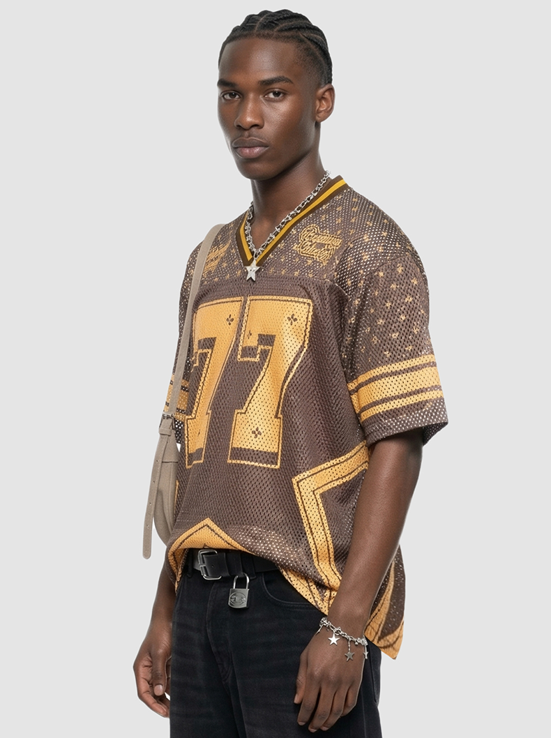 Brown and gold mesh jersey T-shirt with oversized 77 graphic, worn by a model with short sleeves and V-neck trim