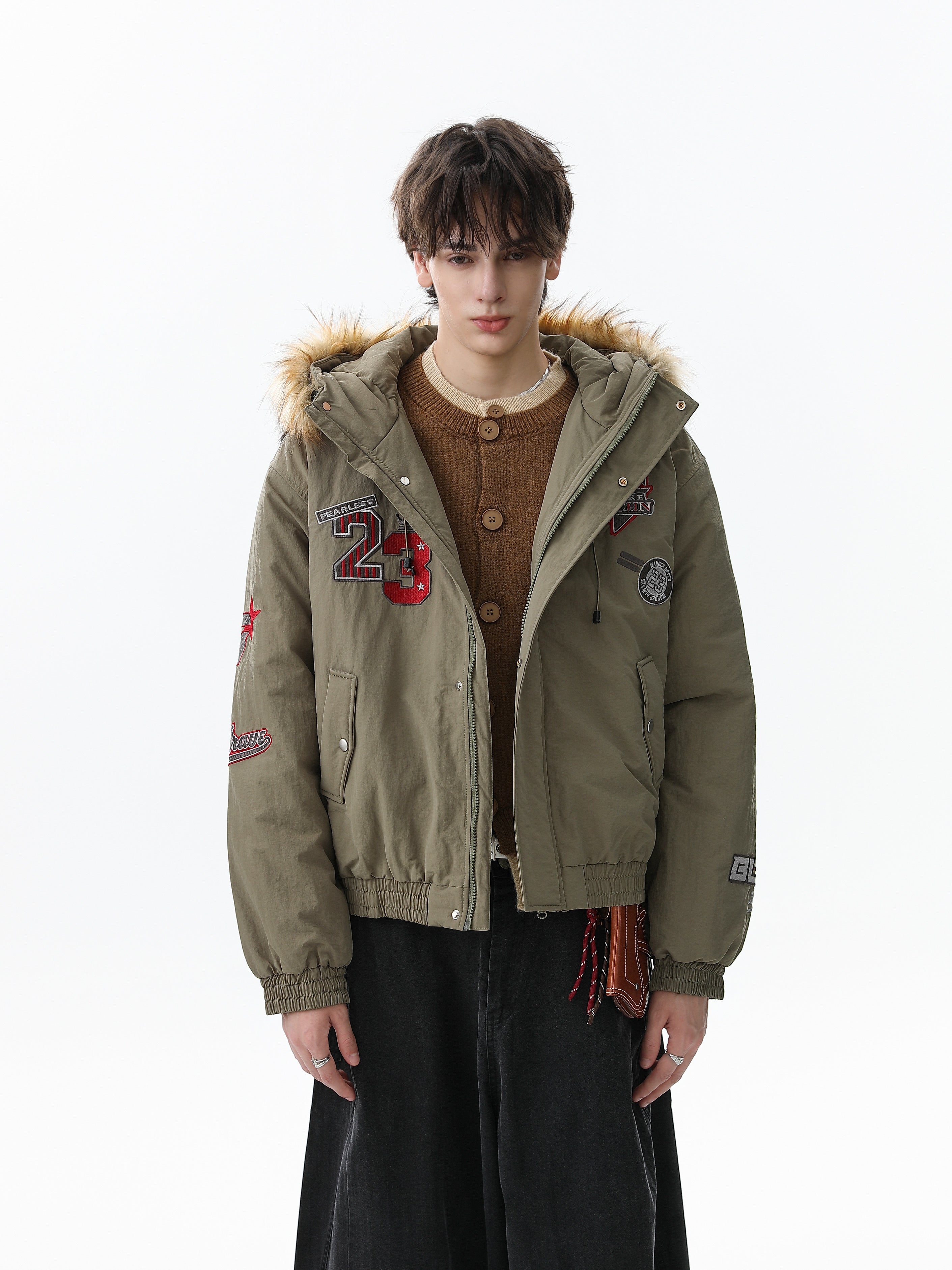 Model wearing army green faux fur hooded puffer jacket, front view with patches