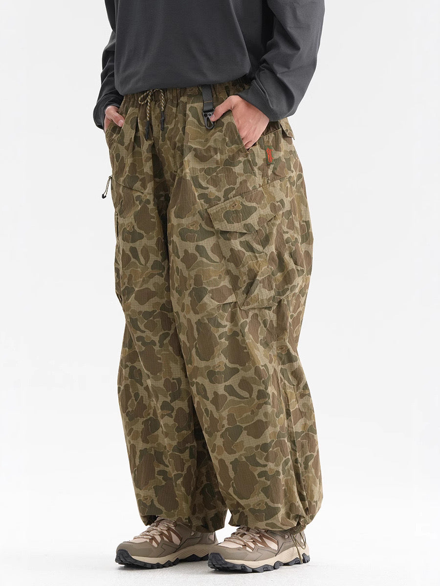 Green camouflage cargo pants worn on model, front view with loose fit