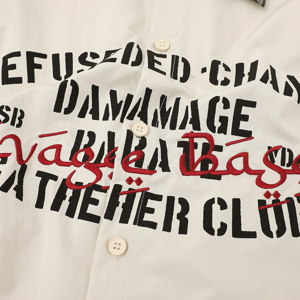 Cream short sleeve streetwear shirt with bold black stencil lettering and red embroidered script across the chest