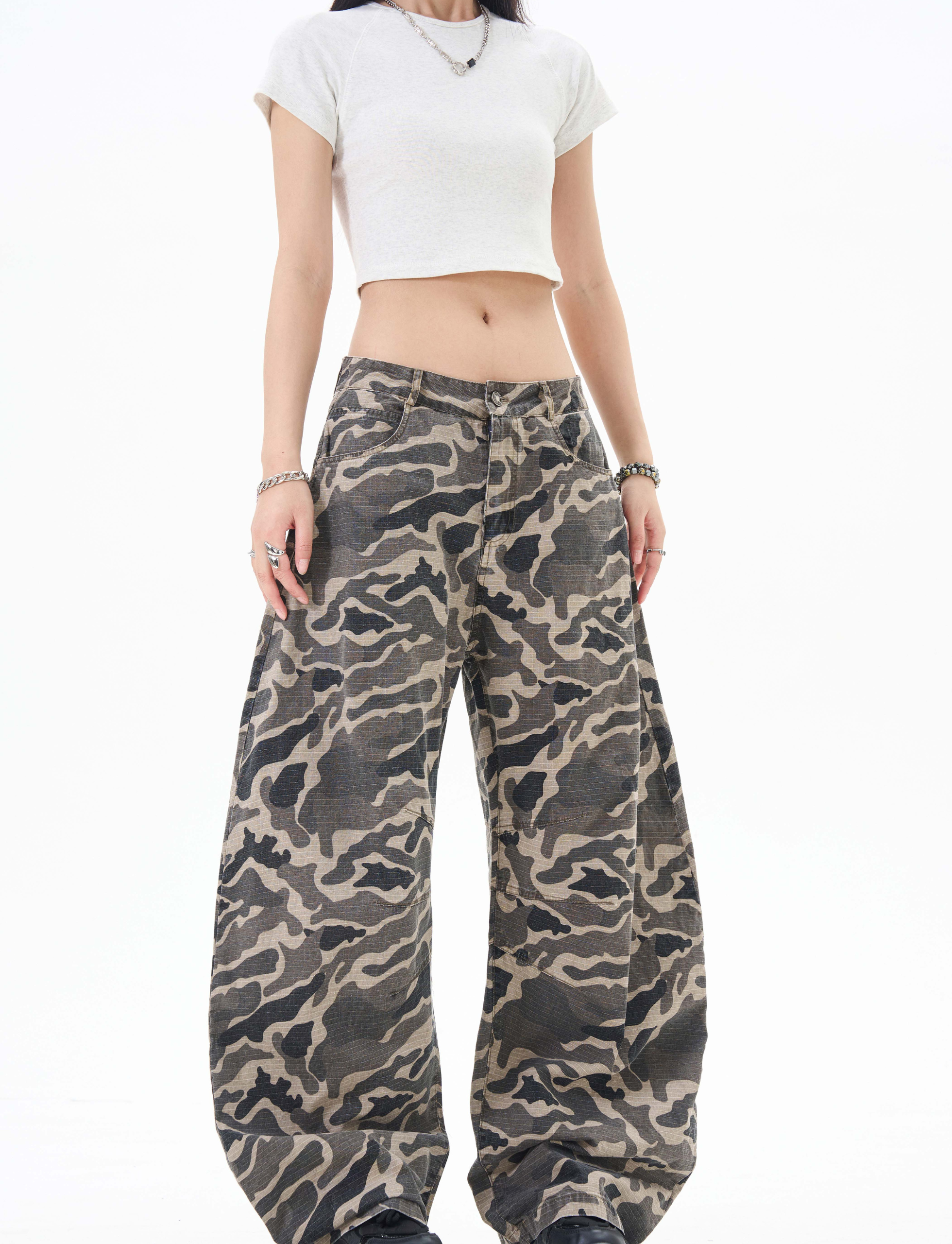 Model wearing grey camo pants, front view showing high waist and wide legs