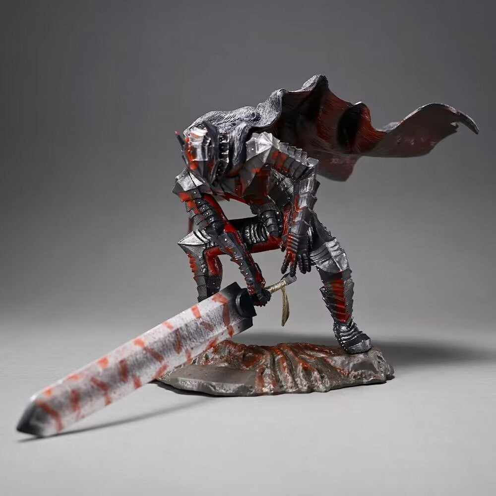 A detailed sculpture of a knight in dark armor with a tattered cape, crouching and wielding a large, cloth-wrapped sword. The base resembles rocky terrain. The knight is primarily red and silver.