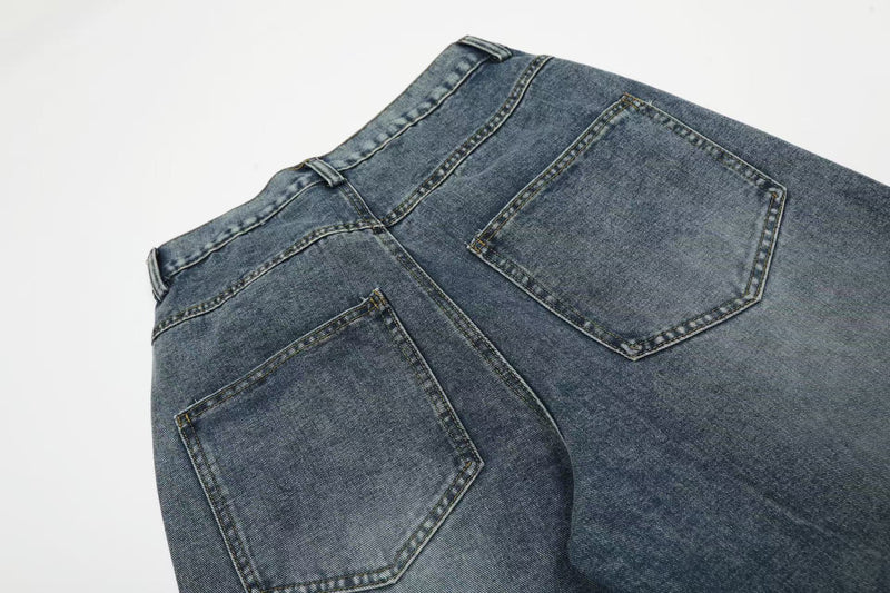 Close-up of back yoke and patch pockets on blue wide-leg denim jeans