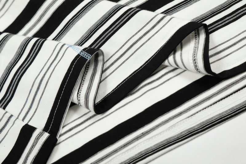 Close-up of black and white striped sleeve and folded fabric with visible seam finishing