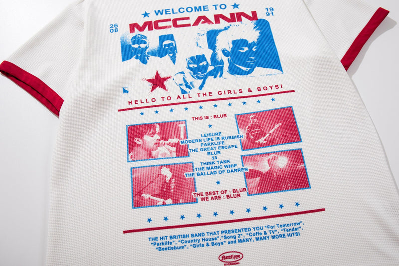 White ringer T-shirt with red trim and a colorful McCANN vintage band graphic print on the chest