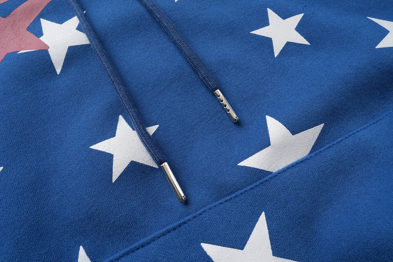 Close-up of blue hoodie drawstrings and metal aglets over white star print