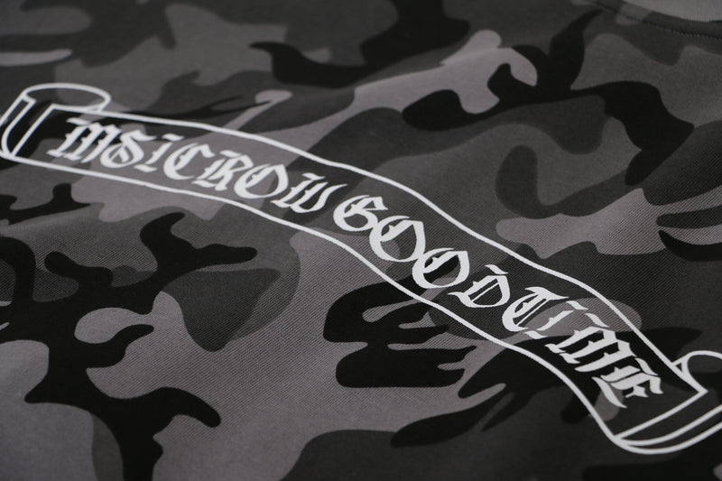 Close-up of gray camo fabric with curved white graphic text