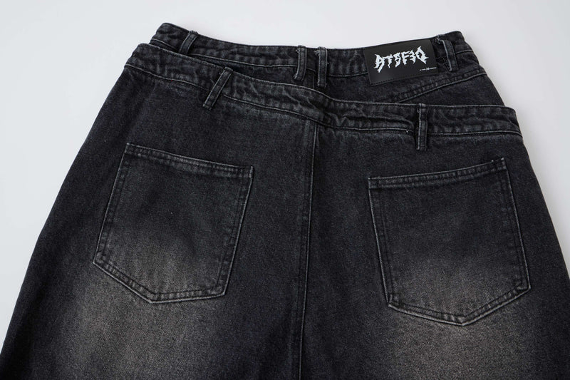 Back view of black denim shorts with layered waistband and two back pockets