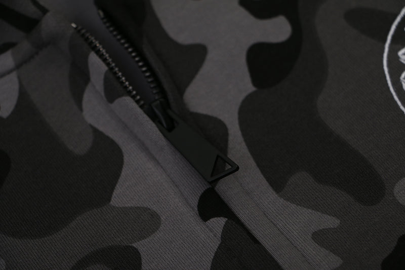Close-up of black zipper pull on gray camo zip-up hoodie