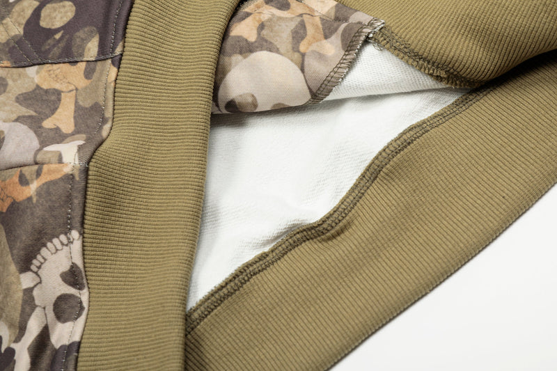 Close-up of jacket lining and ribbed hem detail on camouflage bomber hoodie