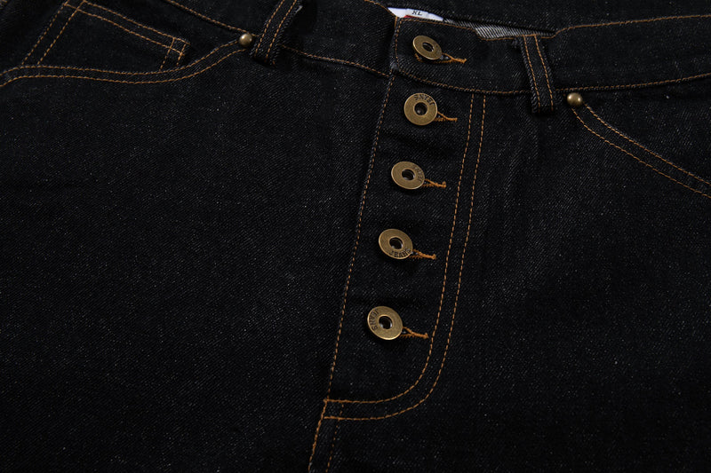 Close-up of the high-rise button fly and front pocket on black denim pants