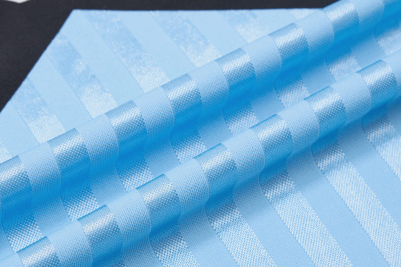 Close-up of light blue striped football jersey fabric with textured woven pattern and raised diagonal folds