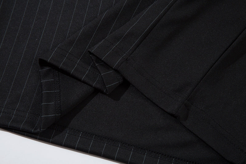 Close-up of black jersey hem, sleeve seam, and pinstripe stitching detail