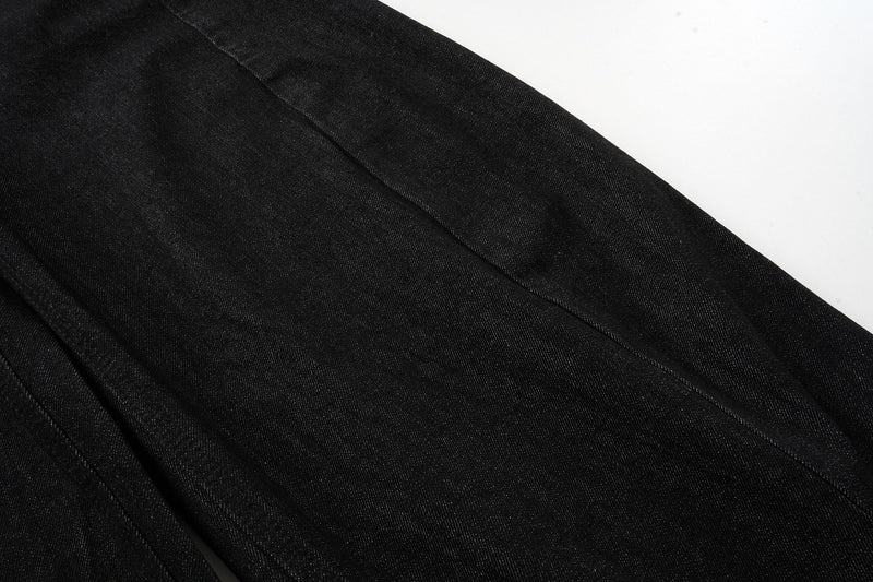 Full-length black denim pant leg with wide cut and subtle seam detail