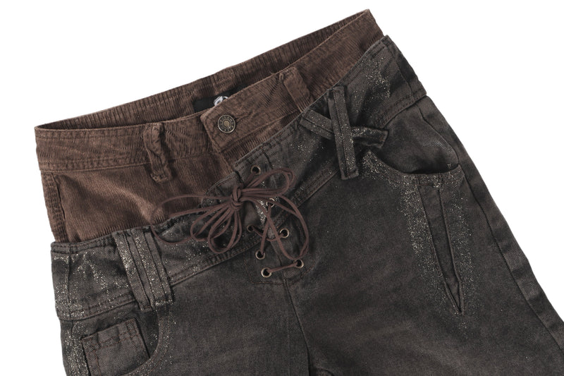 Close-up of dark brown jeans waist with lace-up front and layered waistband detail