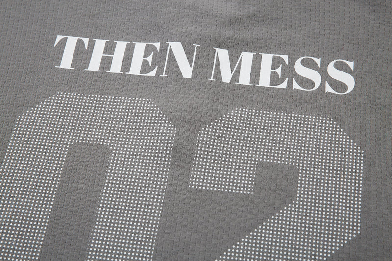 Close-up of gray shirt front with THEN MESS text above the large 02 print