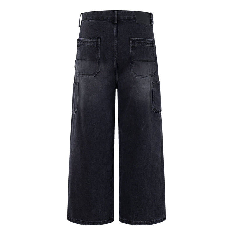 Back view of washed black carpenter jeans with wide legs and large back pockets