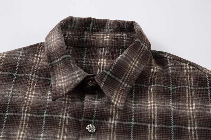 Close-up of brown plaid shirt collar and top button