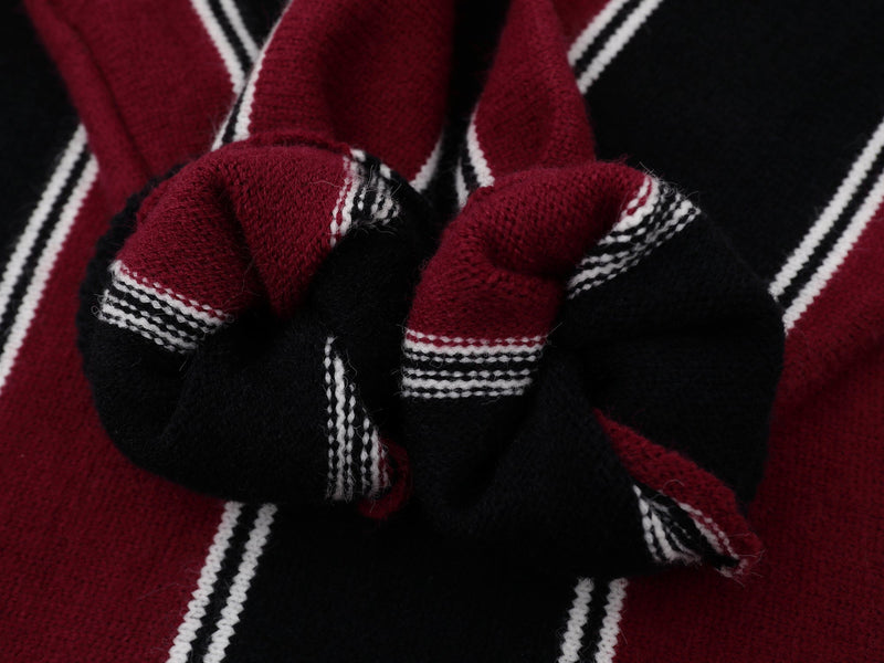 Close-up of burgundy and black ribbed knit cuffs with white stripe trim