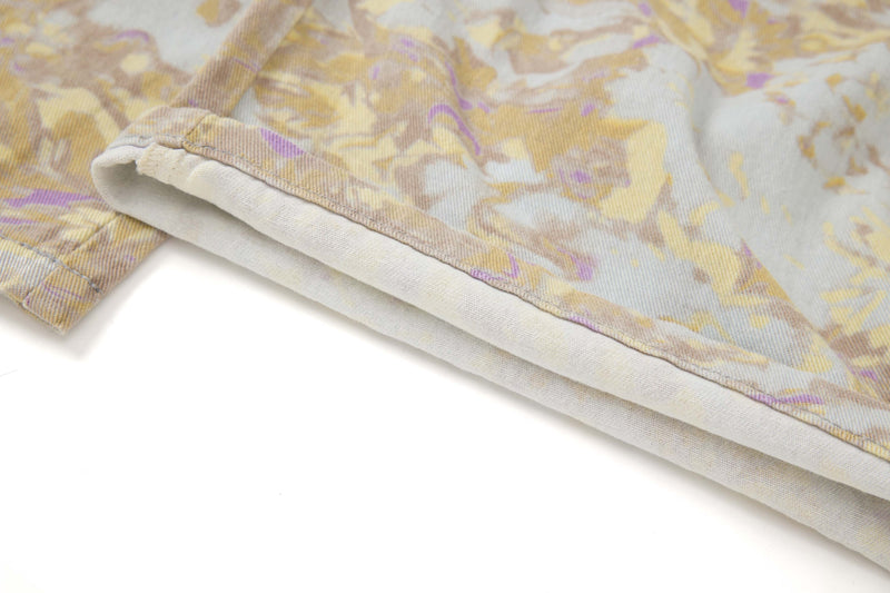 Close-up of the hem on abstract camo cargo pants with folded cuff detail