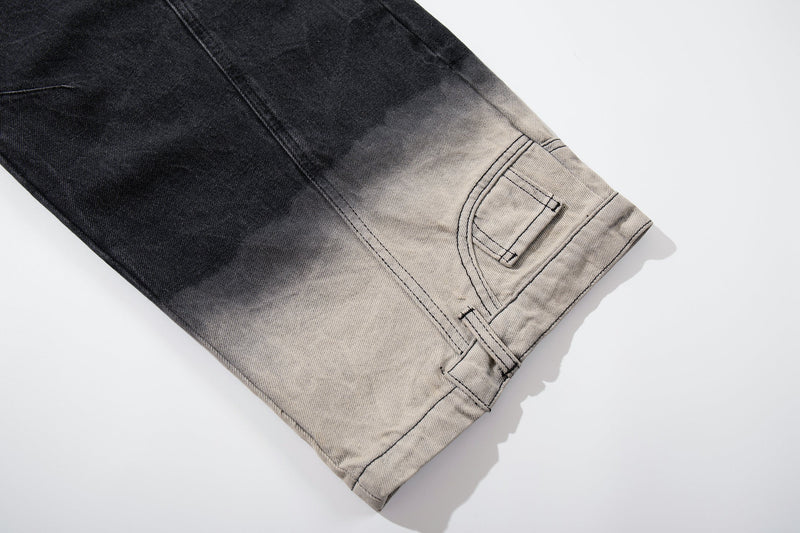 Close-up of the hem on black denim jeans with curved seam and light wash fade