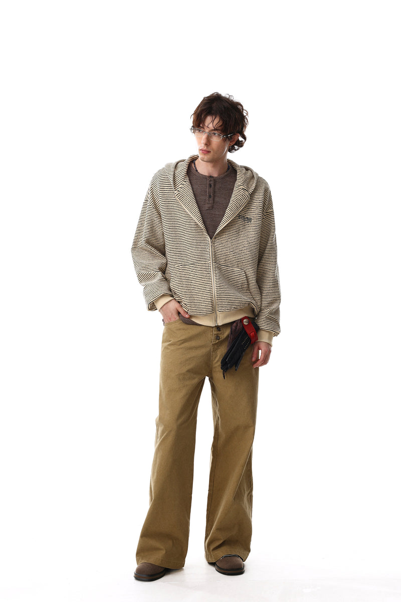 Model wearing cream striped zip hoodie open over a brown shirt