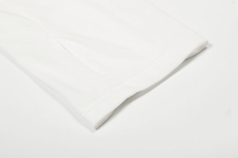 Close-up of white tee sleeve hem with smooth cuff detail