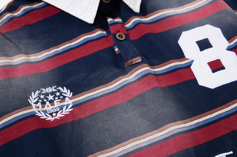 Close-up of chest on striped rugby polo showing MIFA crest and large white number 8 patch