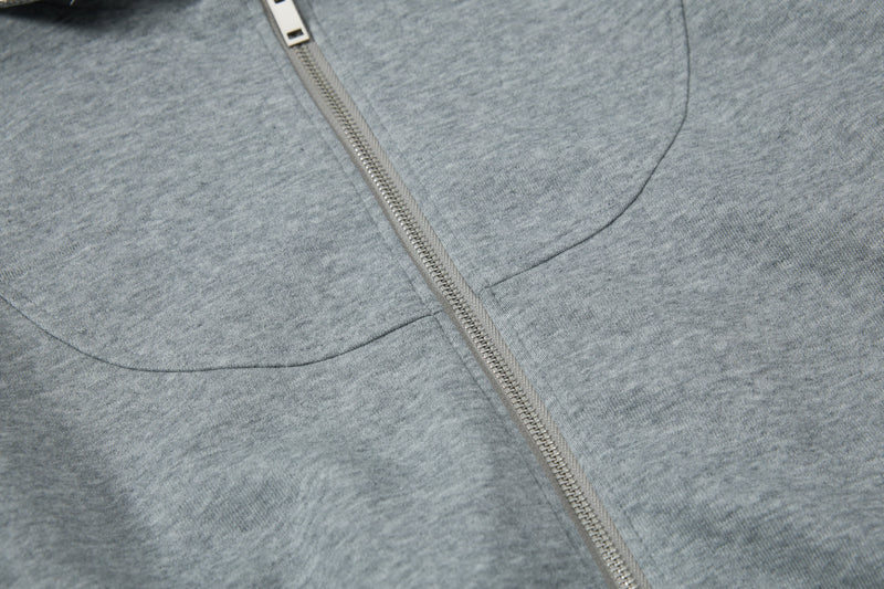 Close-up of front chest seams and zipper on gray hoodie