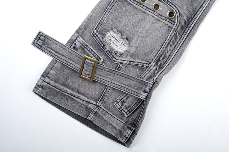 Lower leg close-up of grey wash jeans with strap belt detail, buckle, and frayed rip patch