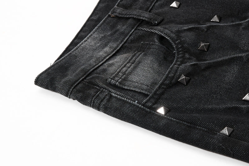 Close-up of back pocket and hem on black studded black jeans