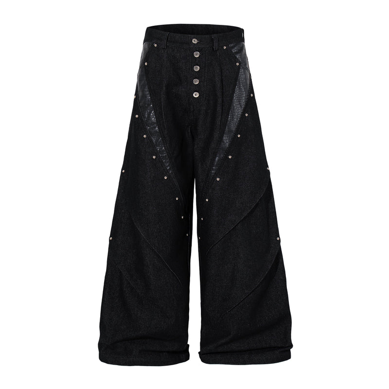 Black wide-leg denim pants with rivets, front view showing panel details and button fly