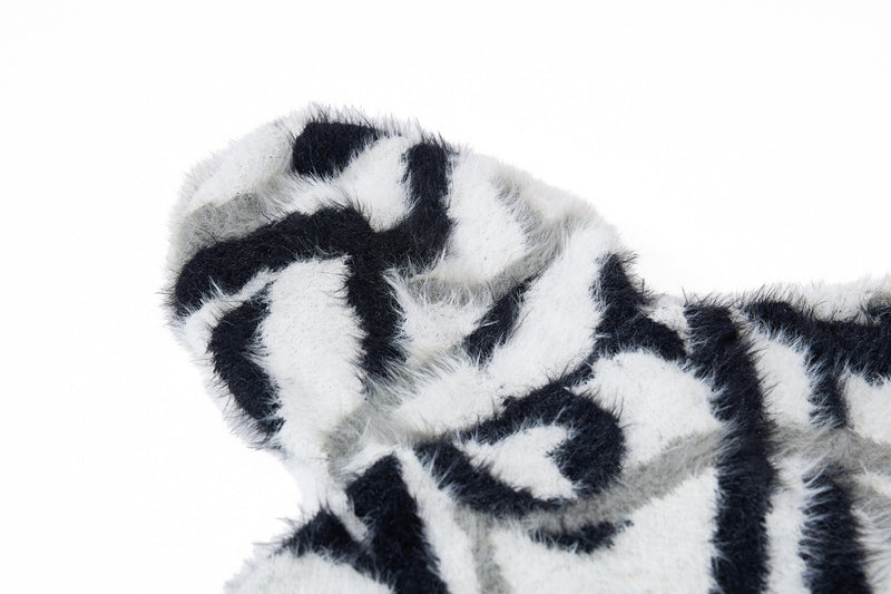 Close-up of black and white faux-fur hoodie hood and shoulder texture