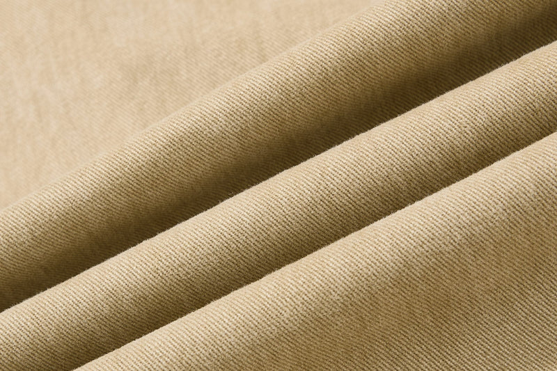 Close-up of khaki cotton twill fabric with visible diagonal weave texture