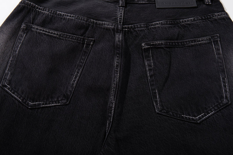 Close-up of the back pockets on dark wash jeans with contrast stitching