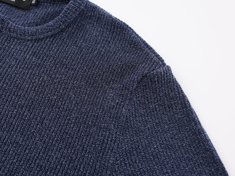 Close-up of navy ribbed knit shoulder and upper sleeve