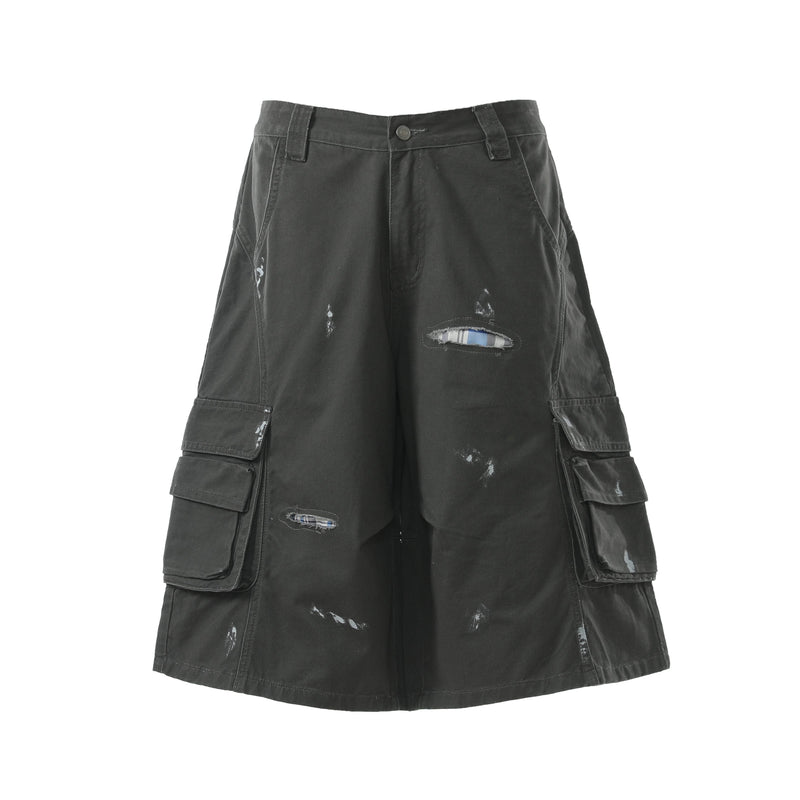 Black cargo shorts front view with plaid-reinforced rip and side cargo pockets
