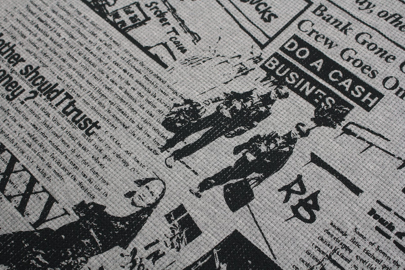 Black and gray gothic collage graphic tee with newspaper-style print and distressed streetwear artwork