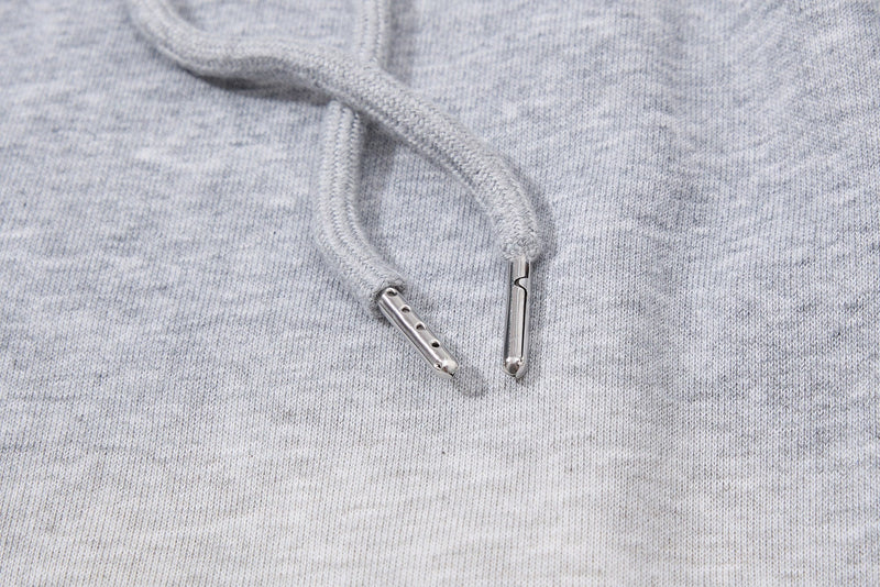 Close-up of gray drawstring tips on light heathered athletic shorts