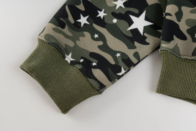 Close-up of olive ribbed cuff and sleeve hem on camo star-print hoodie