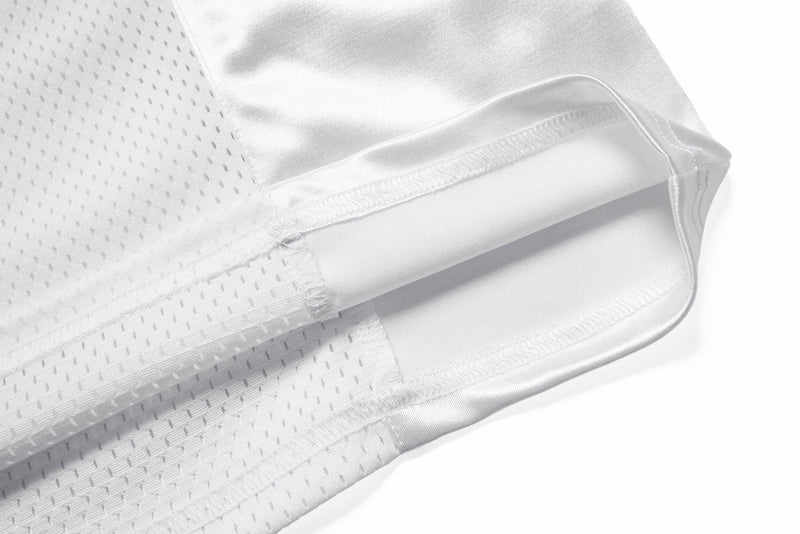 Close-up of white jersey hem and perforated mesh side panel
