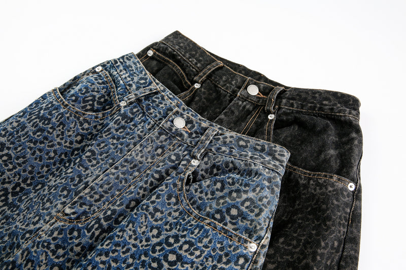 Three pairs of leopard print jeans in blue and black stacked together
