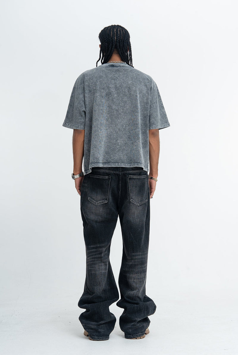 Vintage washed gray oversized tee with a faded graphic tee back view, paired with black wide-leg jeans